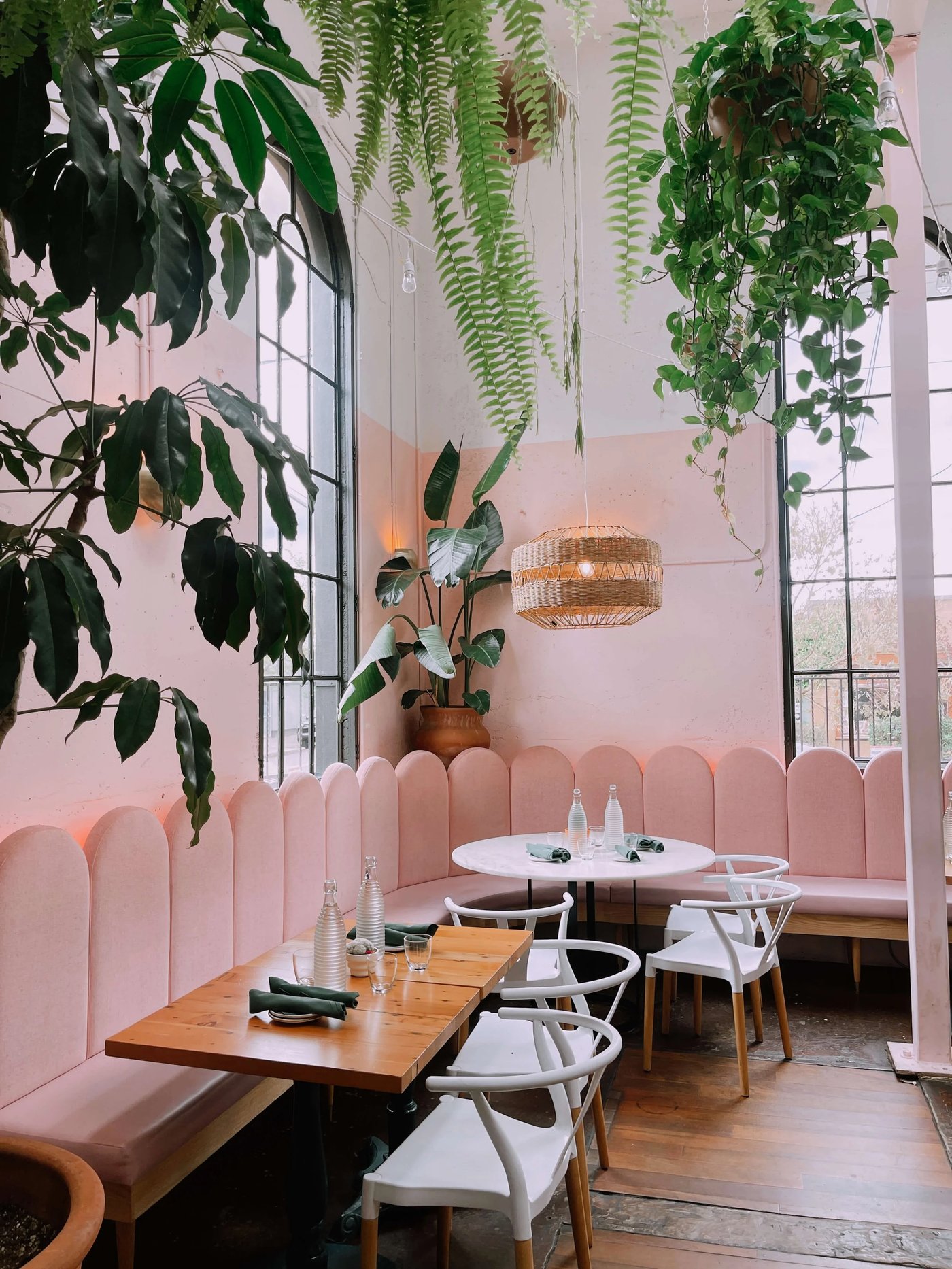 A whimsical and sun-kissed sanctuary that blends candy-colored walls with a lush canopy of indoor greenery. Every corner feels like a celebration of summer, grounded by natural textures and glowing neon accents.