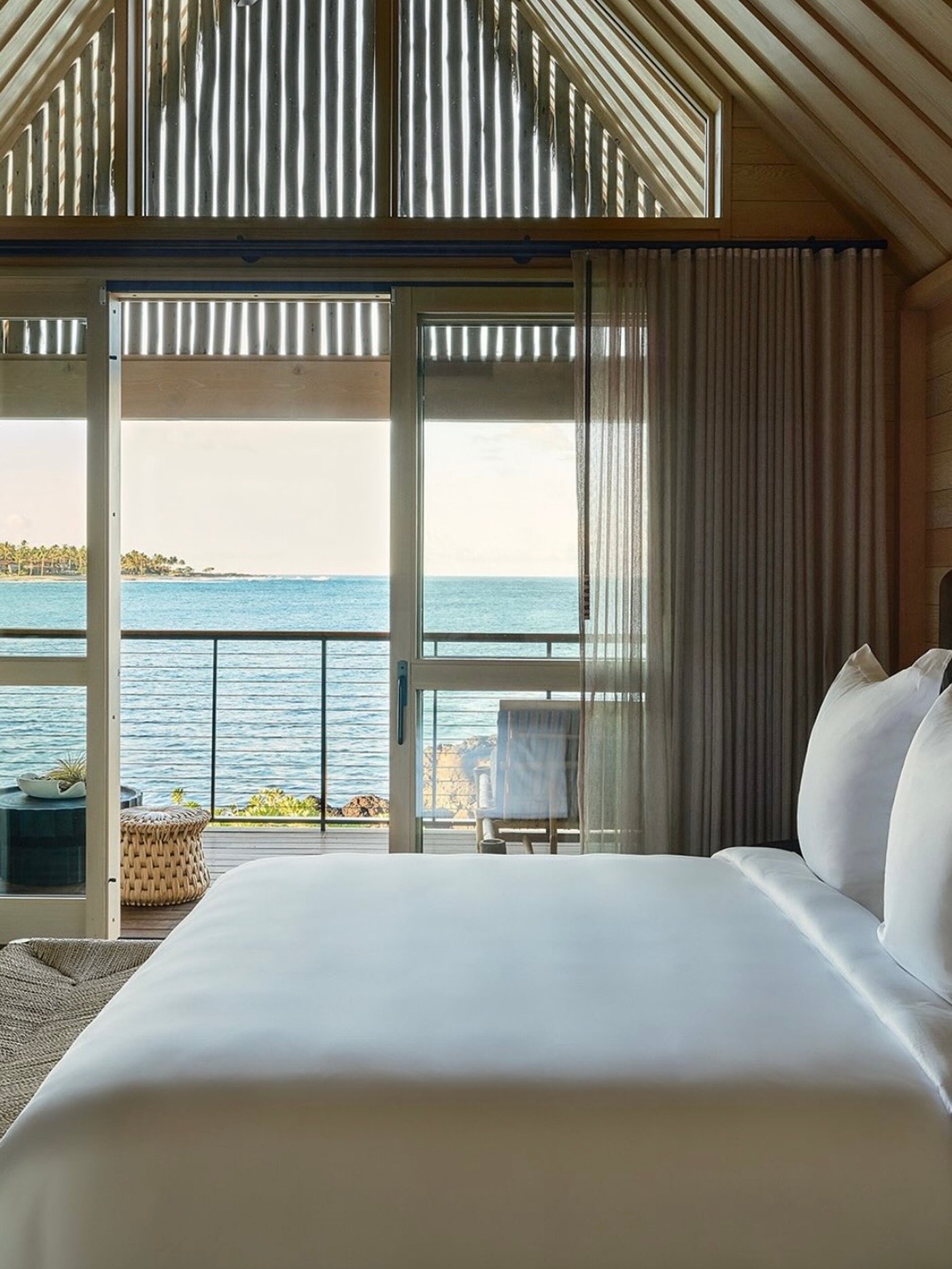 A masterclass in coastal minimalism, this serene sanctuary blurs the line between indoor comfort and the vast Pacific horizon. The warmth of the vaulted timber architecture perfectly frames the breathtaking ocean views, inviting a sense of profound stillness.
