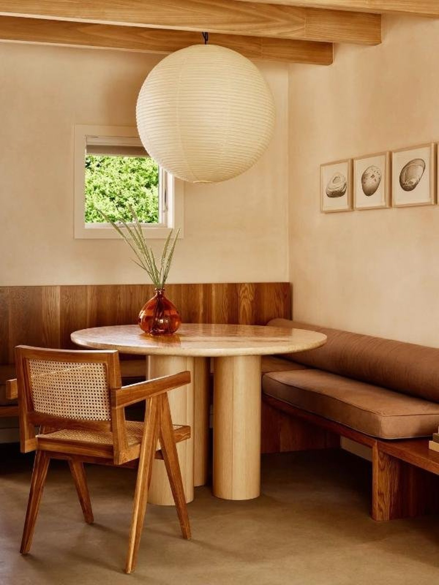A Masterclass in organic warmth, this sun-dappled corner pairs tactile materials like woven cane and travertine for a feeling of grounded, understated luxury. The soft glow of an oversized lantern creates a cocoon-like intimacy, making it the ultimate retreat for a slow, thoughtful morning.