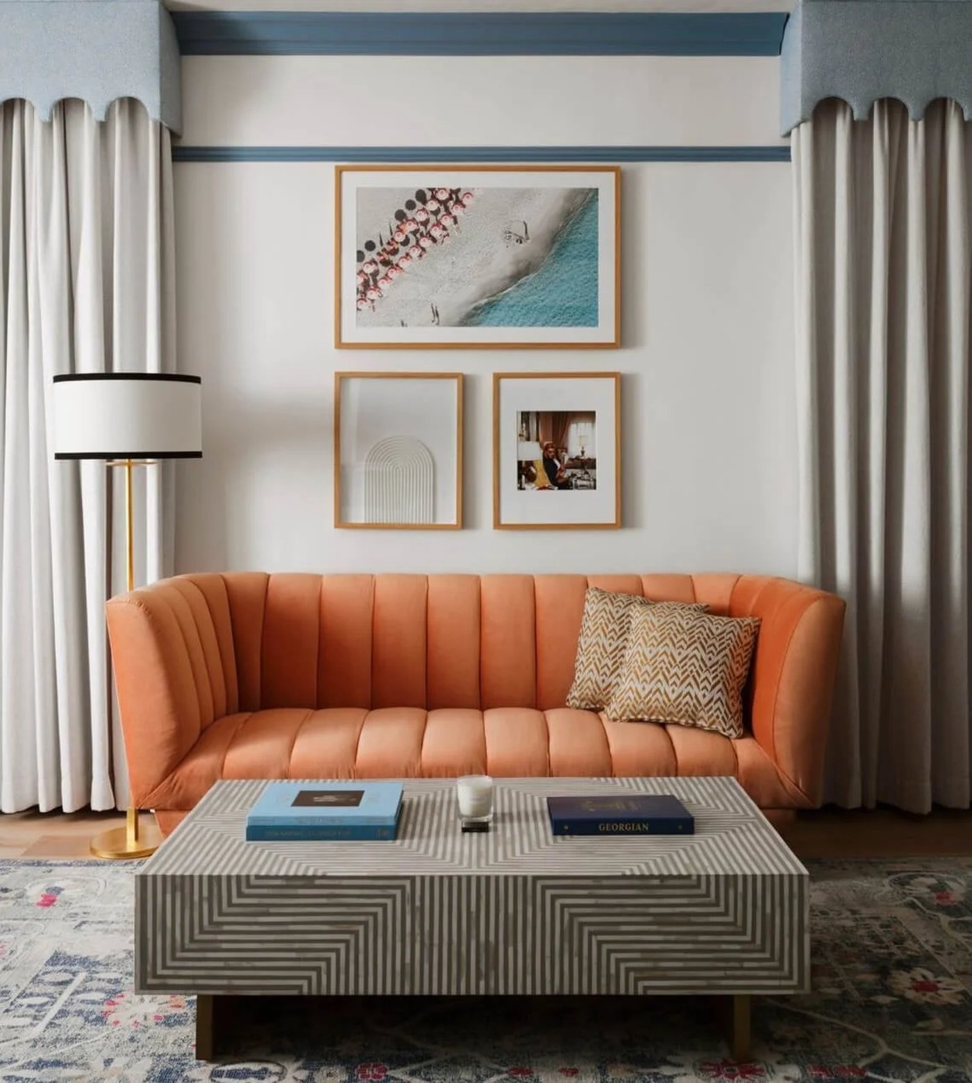 An expertly curated slice of modern coastal luxury, where playful scalloped details and a punchy apricot sofa meet the quiet sophistication of bone-inlay craftsmanship. This space feels like an eternal summer afternoon, blending eclectic textures with a lighthearted, high-design sensibility.