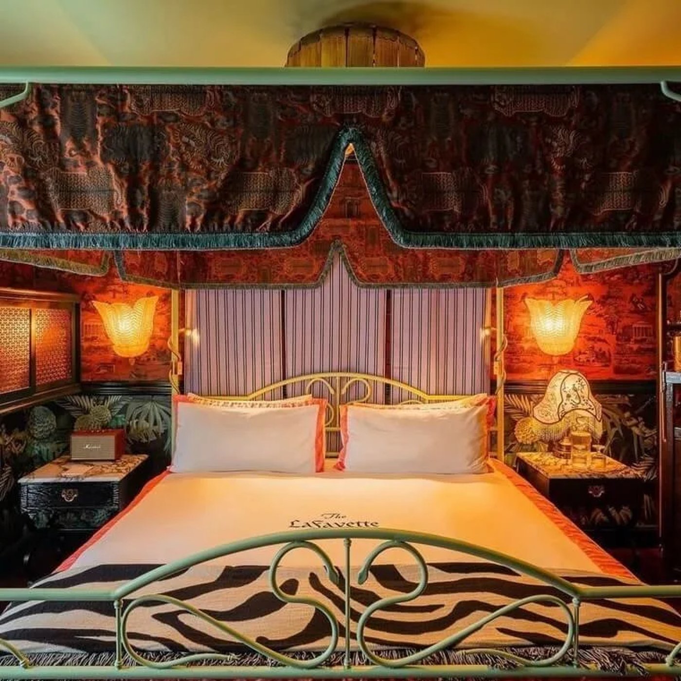 A masterclass in maximalist storytelling, this room wraps guests in a rich tapestry of exotic prints, velvet textures, and warm, glowing sconces. It’s a curated treasure trove that feels like a glamorous, film-set sanctuary from another era.