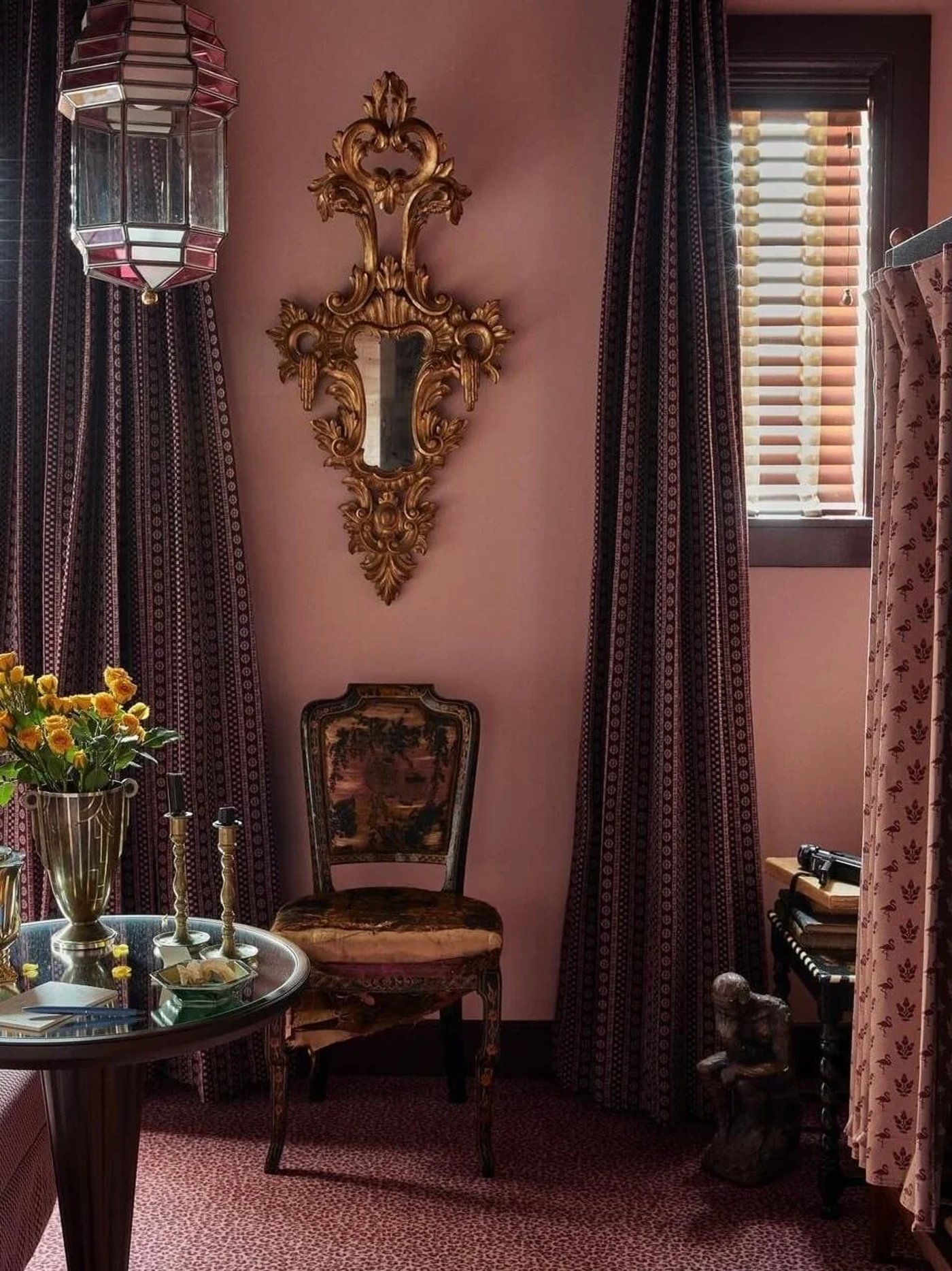 A masterclass in maximalism, this sultry corner envelops guests in layers of dusty rose, ornate gilt accents, and rich, eclectic patterns. It feels like a secret, storied retreat within a grand estate, perfect for hushed conversations and late-night dreaming.