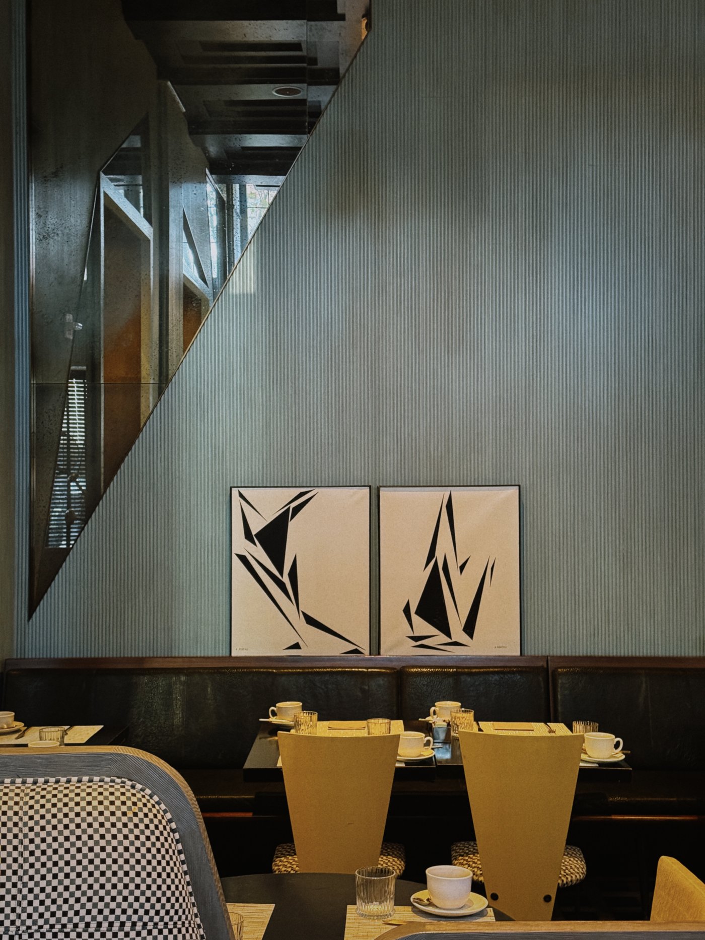 An exercise in tactile minimalism, this corner pairs rhythmic ribbed textures with bold graphic art for a morning environment that feels both grounded and high-design. The play of mirrored reflections and geometric light shadows creates a layered, cinematic depth perfect for a slow, thoughtful start.